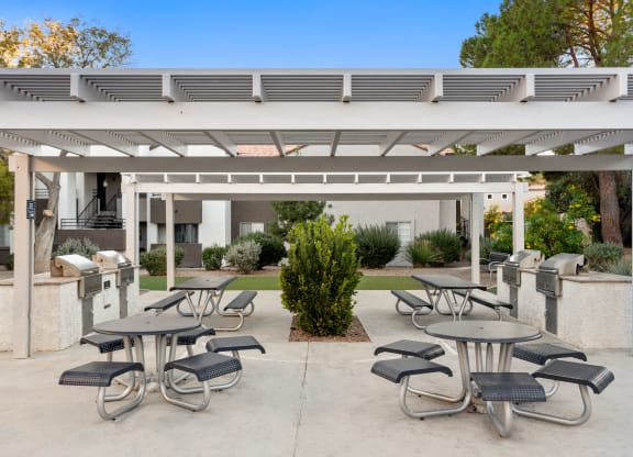 an outdoor patio with tables and chairs